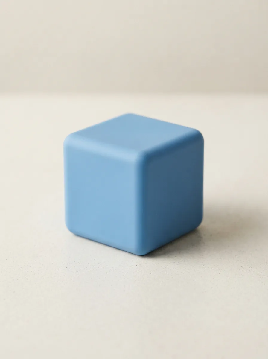 A single NeeDoh Nice Cube in a soft blue color, presented as the main subject on a neutral, minimalist background.